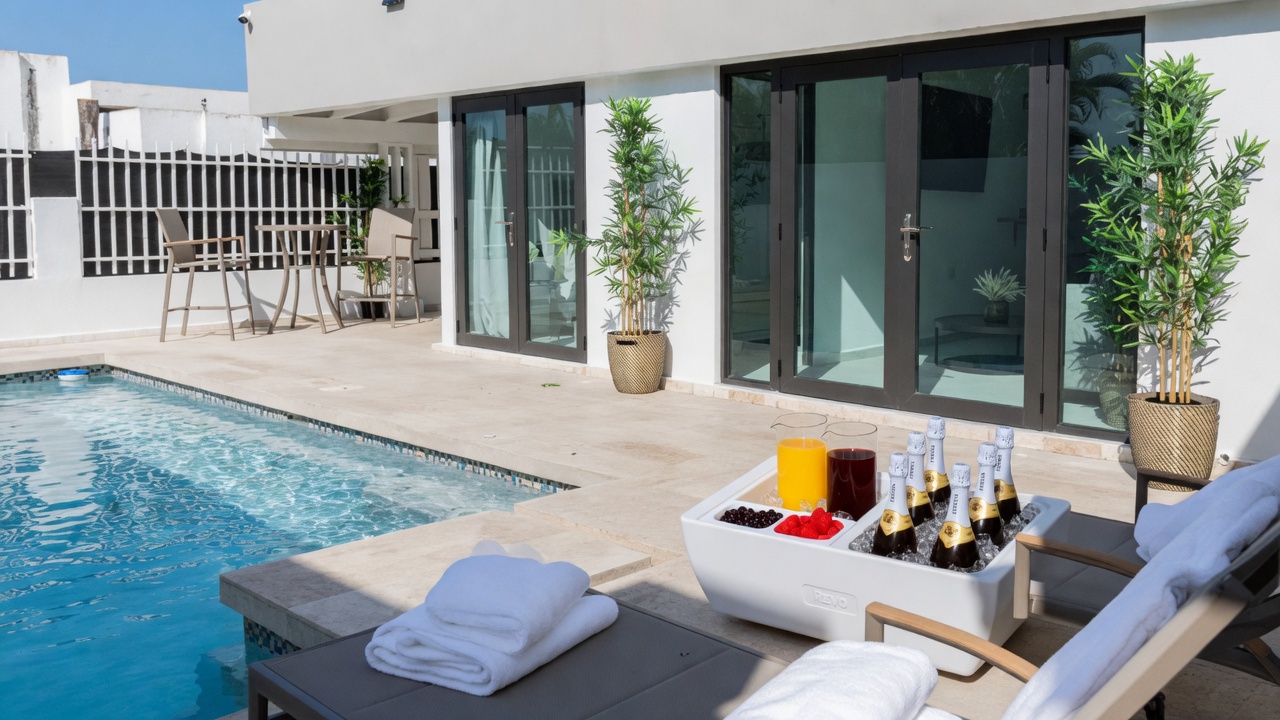 Private Aqua Dorado pool set for a couples weekend in Dorado, Puerto Rico, with fluffy white towels and a champagne and fruit chiller