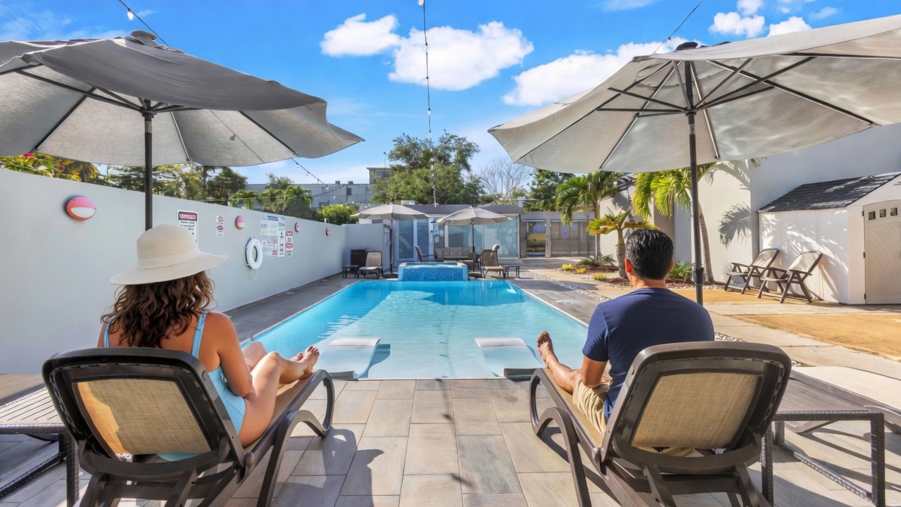 Guests relaxing from behind on lounge chairs at AQUA Ville Moderna 1 pool in Dorado, Puerto Rico