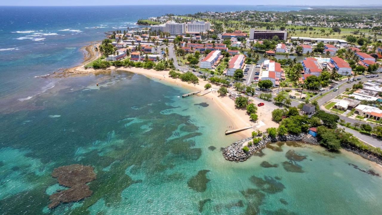 Aerial view of Dorado, Puerto Rico: crescent beach, reef, and the Costa de Oro neighborhood